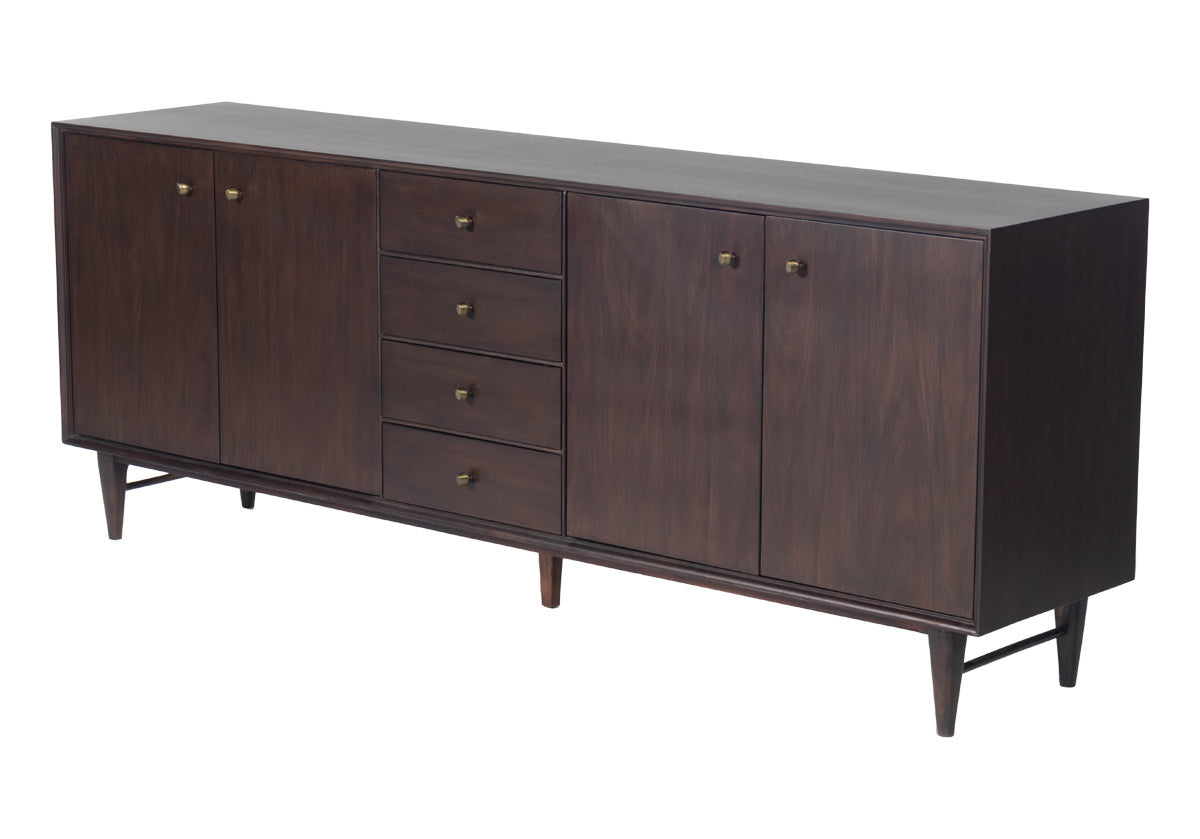 side of The Frank Sideboard gives an elevated, mid-century feel with its handsome design. Its dark mahogany box, doors, and drawers add a rich sophistication to any room. Organic-shaped bronzed knobs provide additional dimension complemented by ample hidden storage. Style in a living room, dining room, office, or bedroom for a one-of-a-kind design.