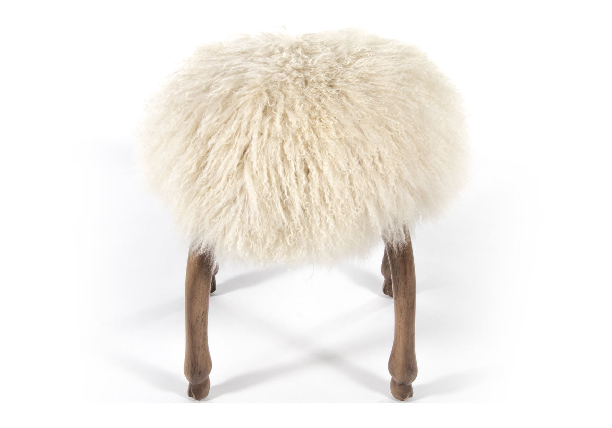 front view of fifi accent stool with its long, luxurious Mongolian sheepskin seat elevated by four animal hoof feet.