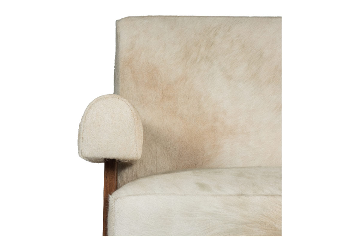 close up of jude lounge cowhide chair arm. walnut frame with cowhide