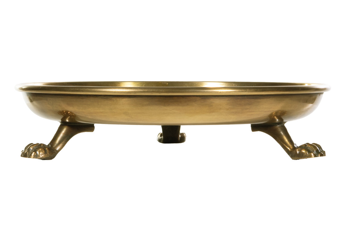 An Alice Lane favorite, this round clawfoot tray is crafted from brass and steel. Its eye-catching lion paw legs represent strength and leadership with balanced thought, action, and emotion. Incredibly versatile, it easily styles as a catchall, candle dish, or decor piece. Its symbolic meaning makes a luxurious, thoughtful gift for anyone.