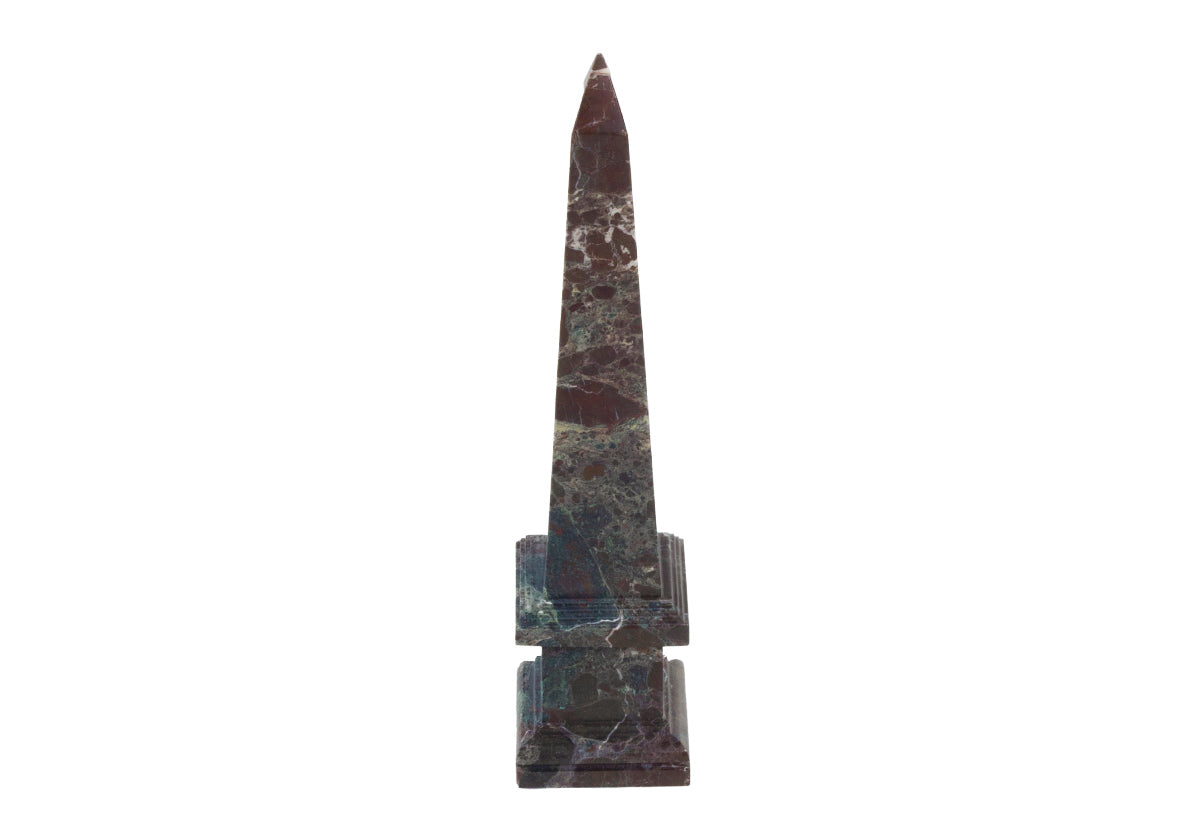 white background with marble oxblood obelisk. 