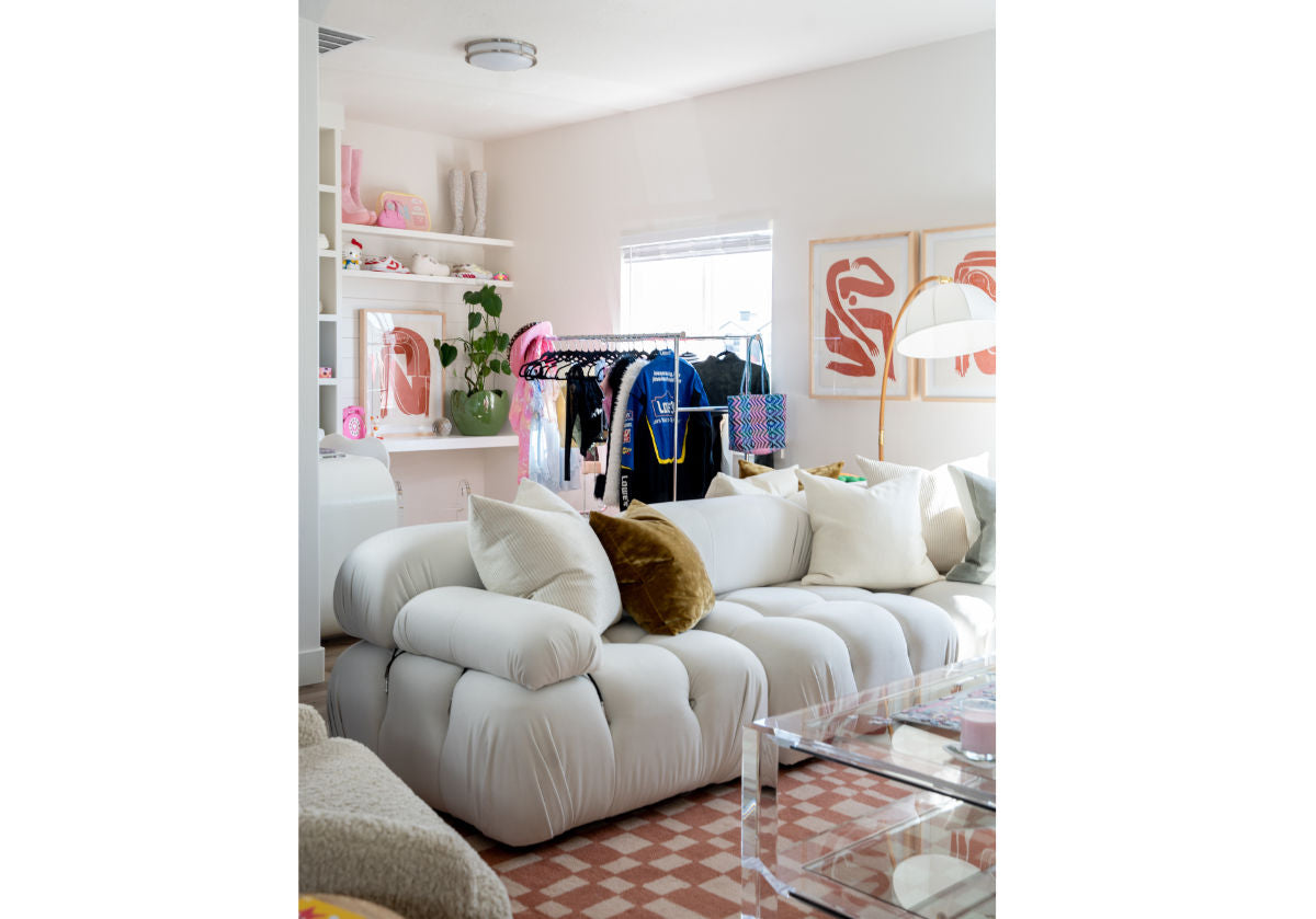 living room picture of sofa on top of white and white chess rug under a glass coffee table. 