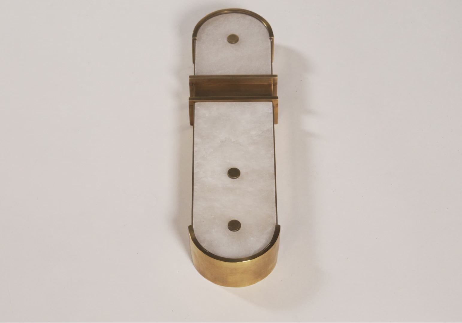 video of domino sconce, white and gold colored wall lamp.