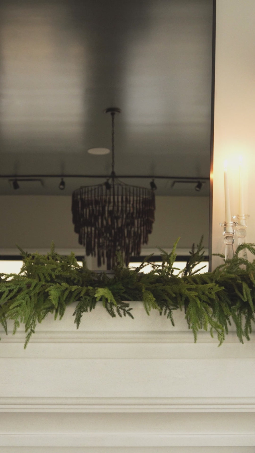 fir garland video, close up of a lovely and large faux fir garland. video shows a fireplace with garland on top at alice lane. and other home decor accessories. 