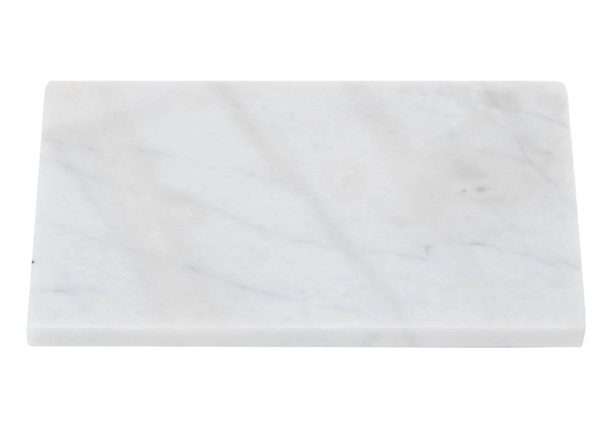 large, white marble cutting board on white backdrop. 