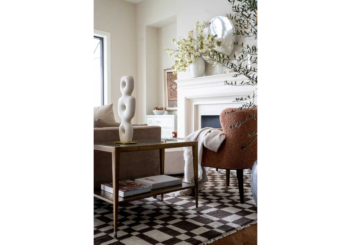 the chess rug with brown and white checkered design with a side table and a sofa with a chair on top of it. 