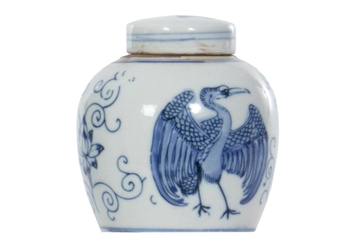 Chic and timeless, this petite temple jar adds a classic touch with its rounded form complemented by a smooth lid. Showcasing beautiful wings, handsome cranes are intricately painted around the vessel, balanced by a flowering design. Available in three small-scale sizes, style one alone or mix and match together for a cohesive, collected look.