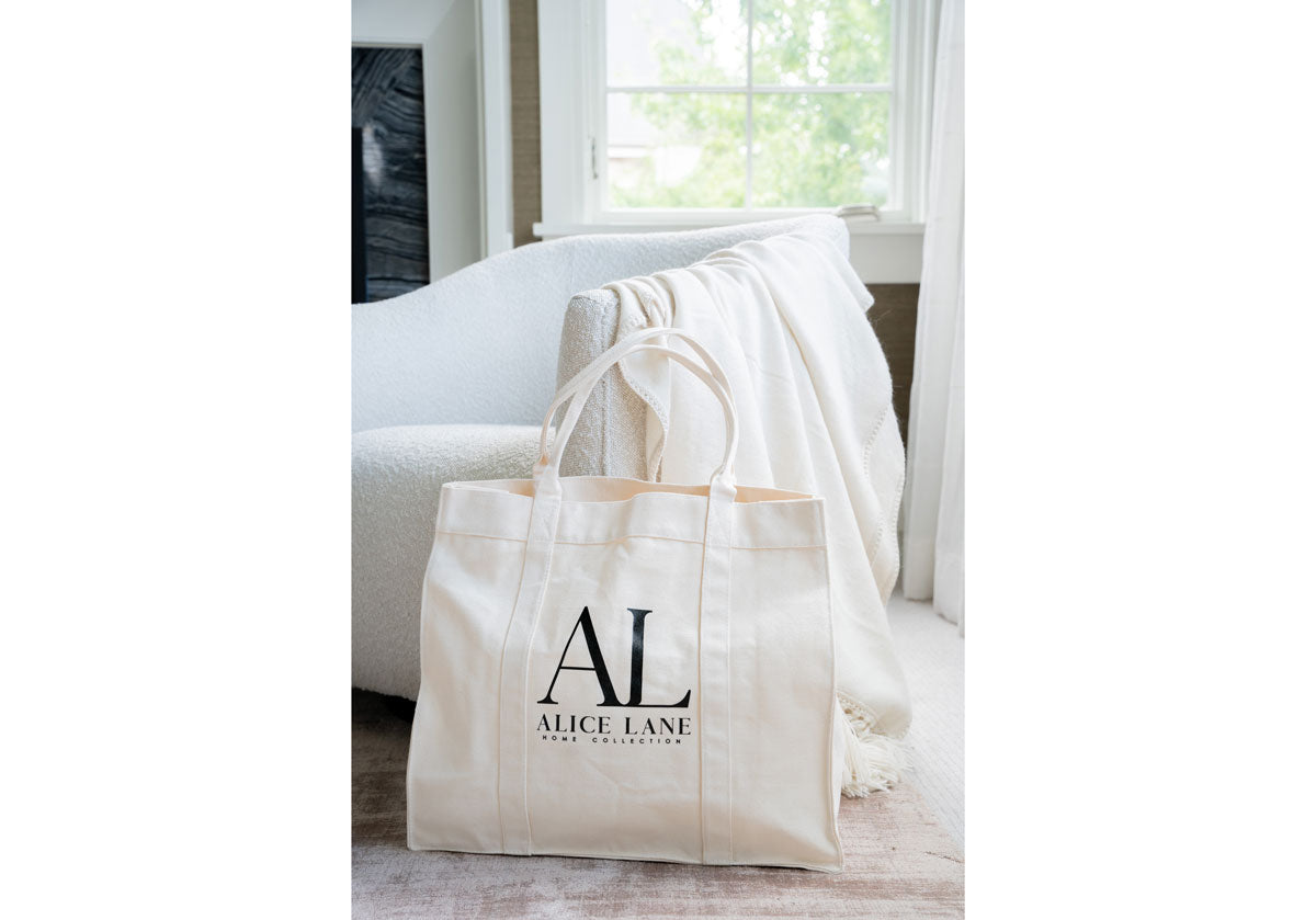 The Alice Lane Tote bag features a natural, organic canvas color complemented by durable handles. Available in two sizes!