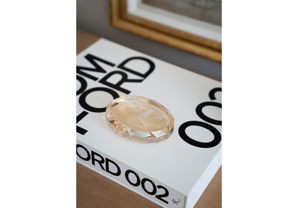 lifestyle photo of crystal dish on a tom ford book 