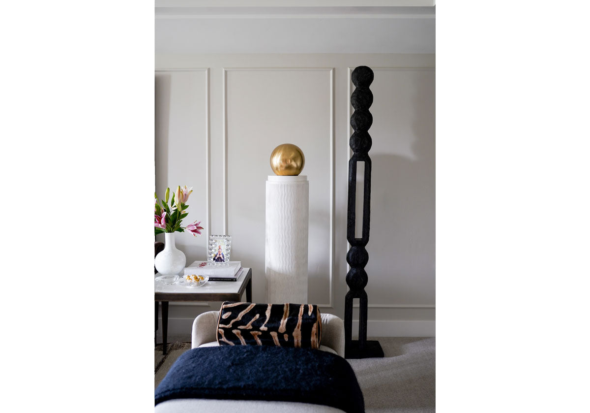 atticus column standing next to a black totem and crystal orb frame. 