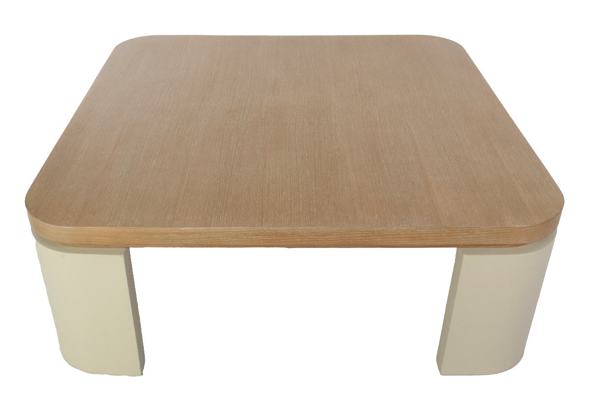 top down view of the Blair Cocktail Table makes a sculptural statement with its spacious white oak top elevated by four radius legs. The natural wood graining and patterning provide a beautiful contrast to its smooth, creamy base for an elevated design.