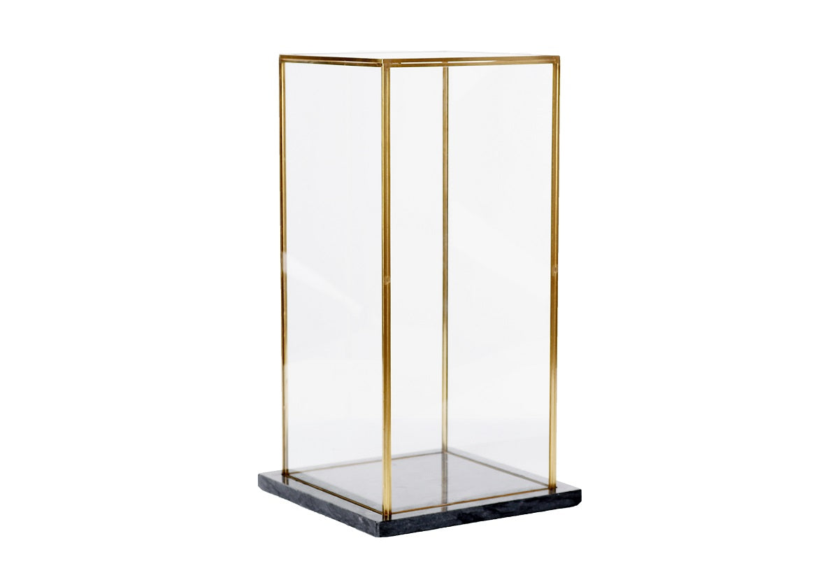 This display box beautifully showcases a treasured vase or pot. Its tall, rectangular form provides simple elegance with its clear glass panels and brass edging. A squared marble black base provides an elegant contrast for a look that is lush and tasteful.