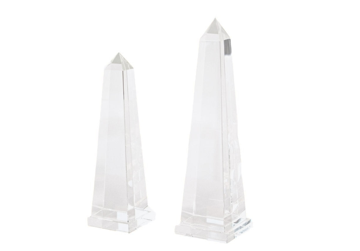 2 different sized crystal obelisks on a white background. 