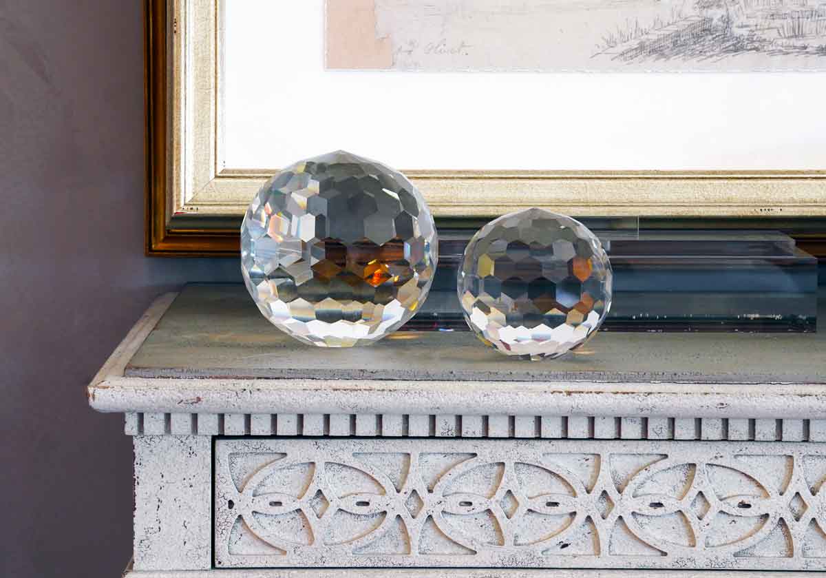 two different sized crystal orbs on a mantle