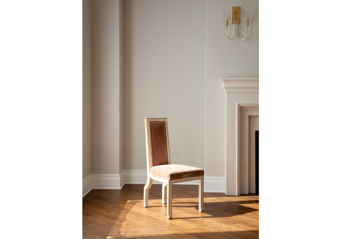 Make a statement with the beautifully dramatic Felix Chair. Its straightforward silhouette is accentuated by its elongated back and incredibly soft antiqued terra mohair upholstery. A smooth white finish outlined in gold further elevates its striking design. Display one as a focal point or style multiple around a table for an added look of luxury.