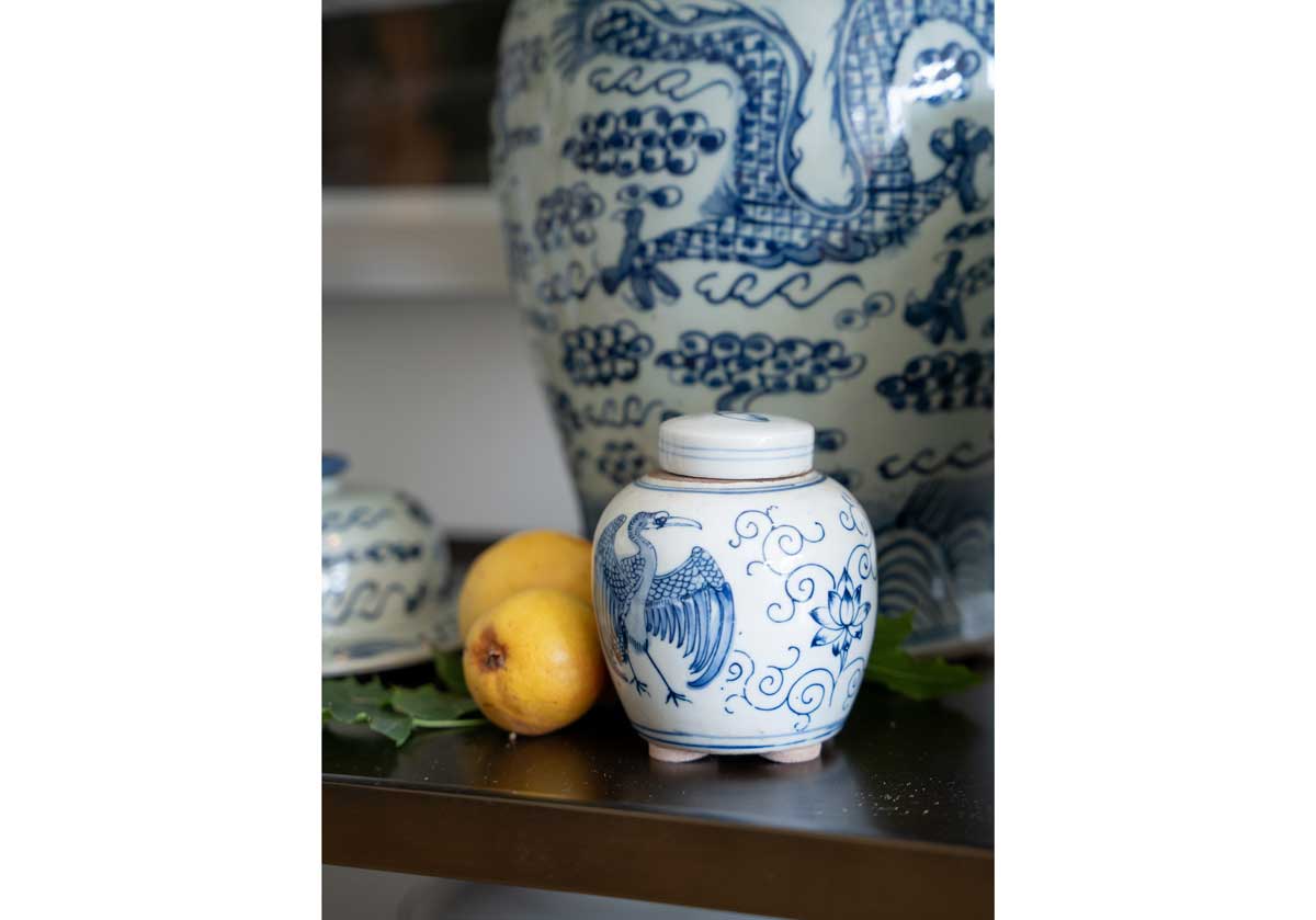 lifestyle photo of the small crane jar next to small lemons and a larger jar in the background. 