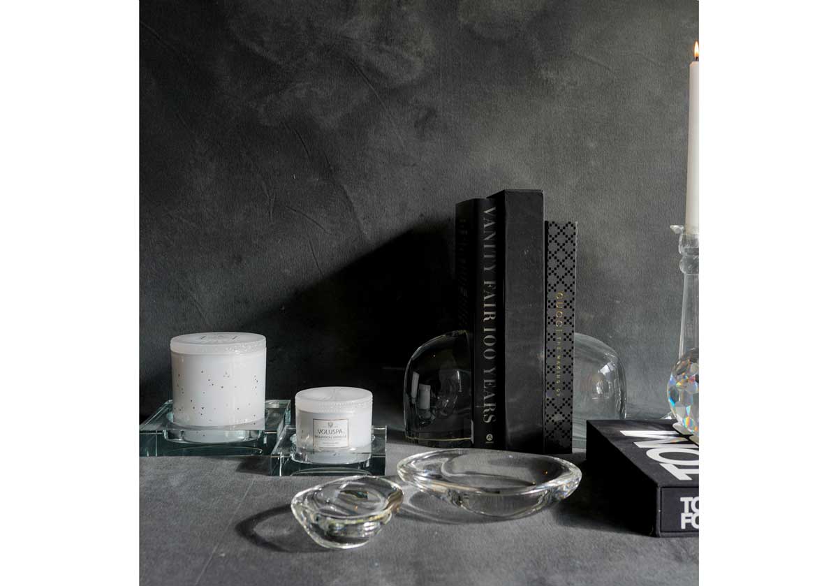 lifestyle photo of the crystal bookends with other crystal products such as candle holders and other crystal dishes. 